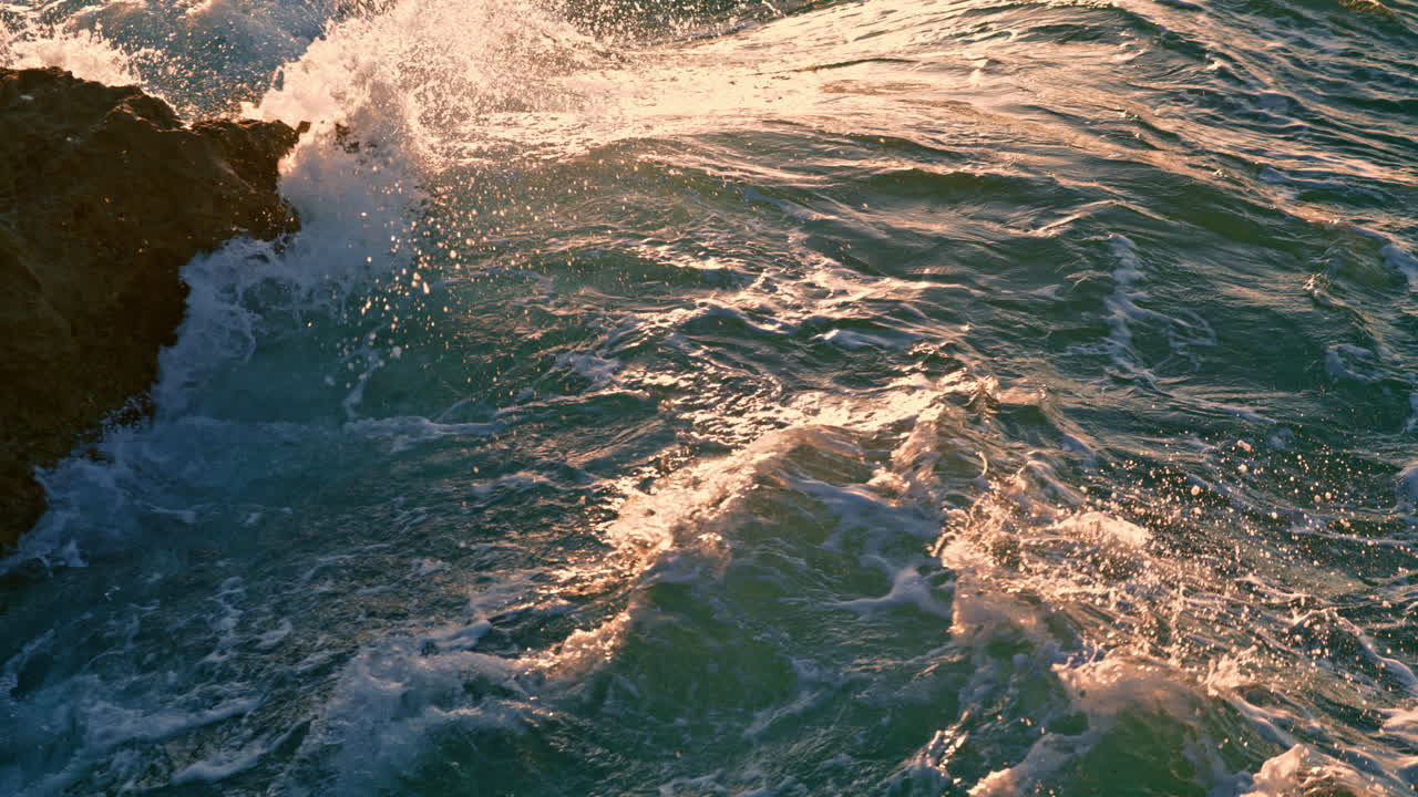Foamy water splashing at crag sunny nature close up. Stormy marine landscape