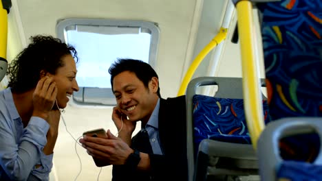 couple listening music on mobile phone while travelling in bus 4k