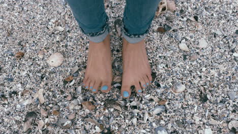 top view woman feet standing barefoot on beach enjoying summer vacation relaxing at seaside