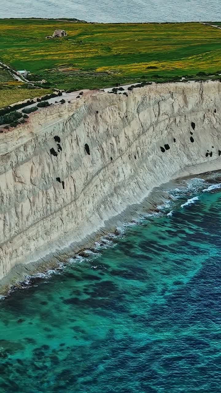 Coastal cliffs and clear waters in Malta during daytime