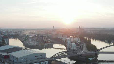 Wide-Establishing-Shot-over-Docks-Port-Area-with-Rivers-in-morning-Sunlight-in-Frankfurt-am-Main,-Aerial-forward-slow