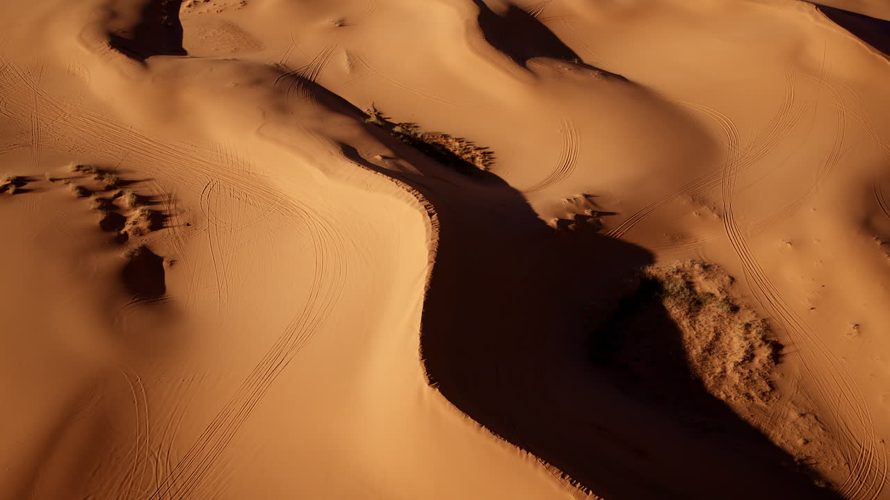 A bird’s-eye view reveals the enchanting shapes and rich colors of pink sand dunes in southern Utah.