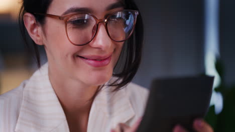 Happy-Woman-Counts-Profits-on-Calculator-in-Office