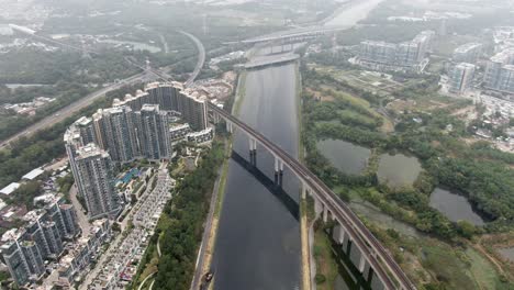 aerial view of an mtr train bridge crossing in sha tin, hong kong