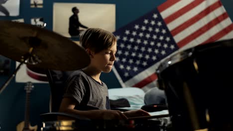 boy playing drums in bedroom