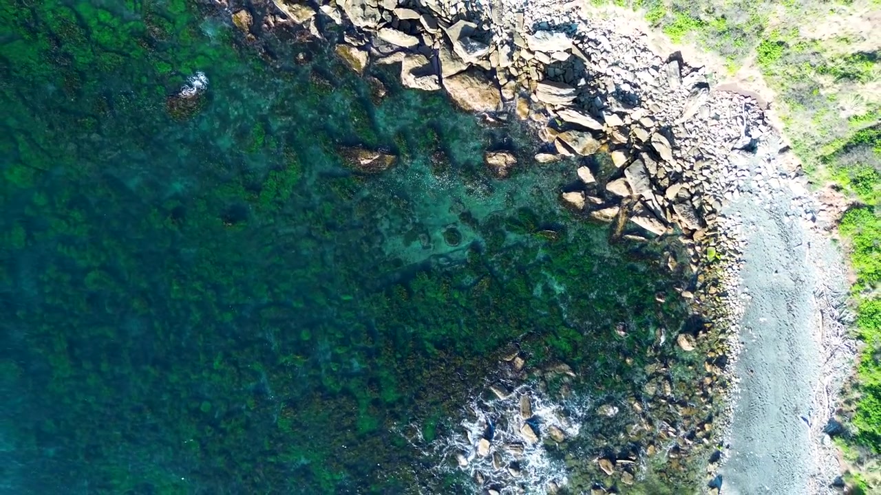 Drone aerial landscape of rocky reef inlet crystal clear water channel with seaweed in bay on Central Coast Sydney Australia nature travel hiking tails tourism