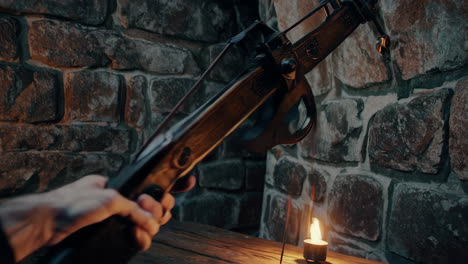 person handling a crossbow in a medieval setting.
