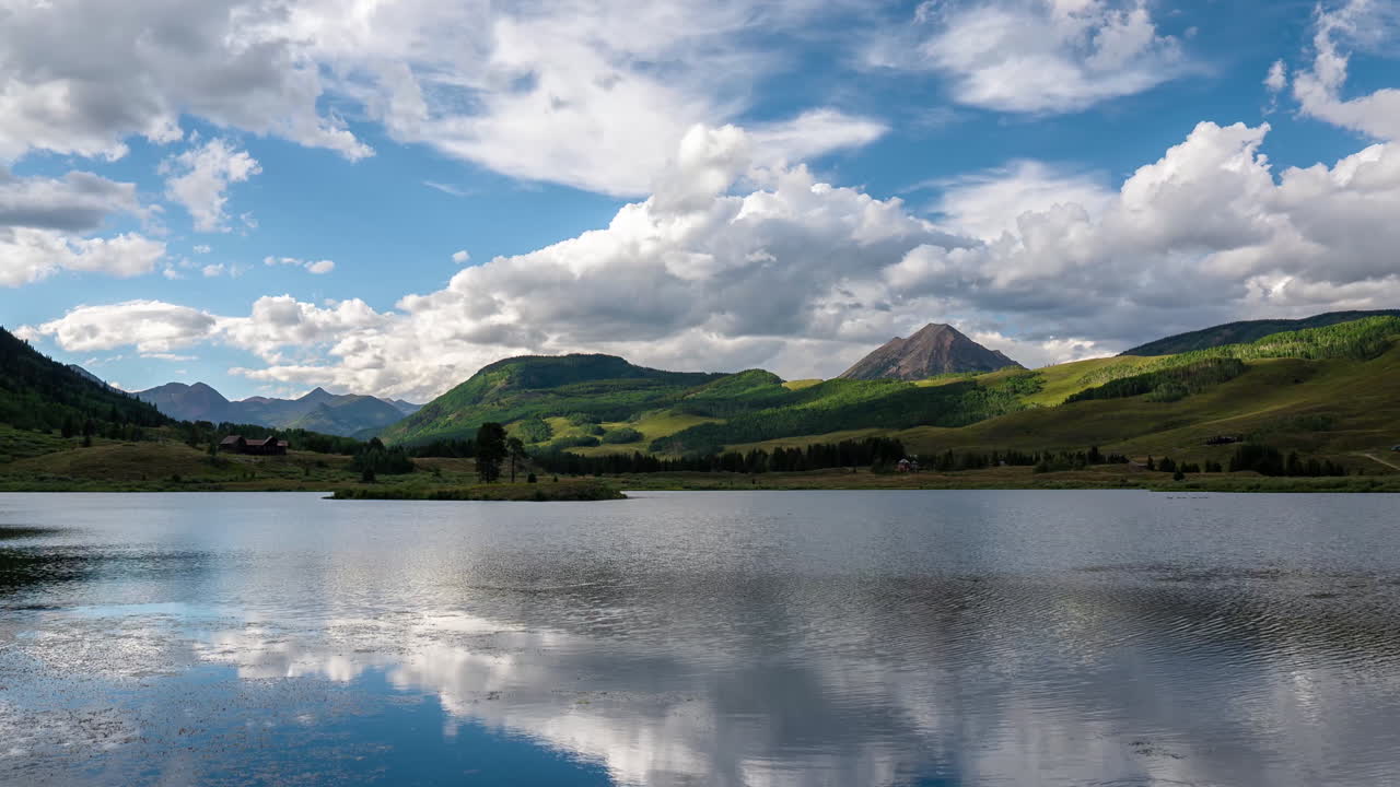 Timelapse of Clouds Reflection on Peanut Lake and Green Landscape of Gothic Mountain, Crested Butte, Colorado USA