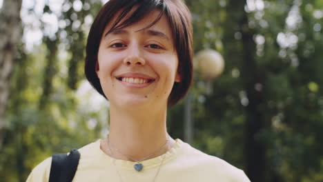 portrait of smiling college girl outdoors
