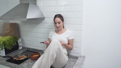 woman eating in kitchen