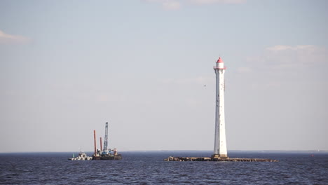 lighthouse and construction work on the water