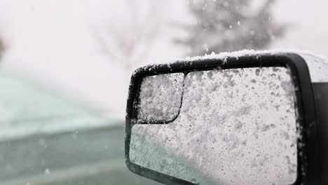 heavy snowflakes snow falling on drivers side truck mirror in a winter storm 60fps