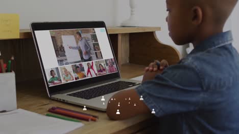 animation of icons and data processing over african american schoolboy online schooling on laptop