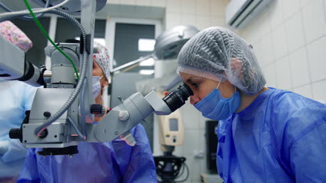 close up of cataract surgery. surgeon working near the microscope in operating room