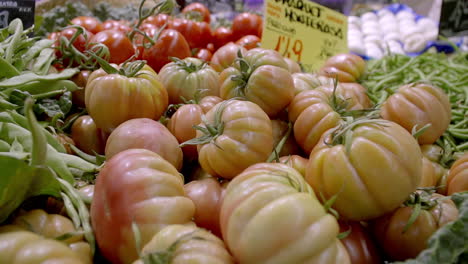 close-up of fresh tomatoes and vegetables at a market stall