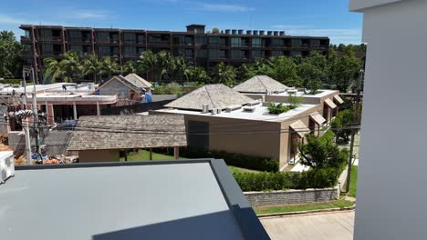 view of modern buildings and rooftops in a tropical urban setting