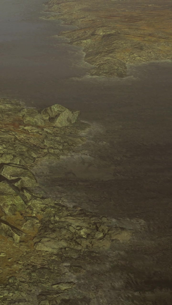 Rocky shoreline with water and distant land on a cloudy day near a lake