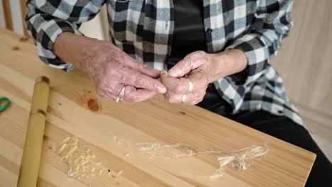 Whisperer-from-Poland,-folk-rite,-old-woman-preparation-for-burning-flax