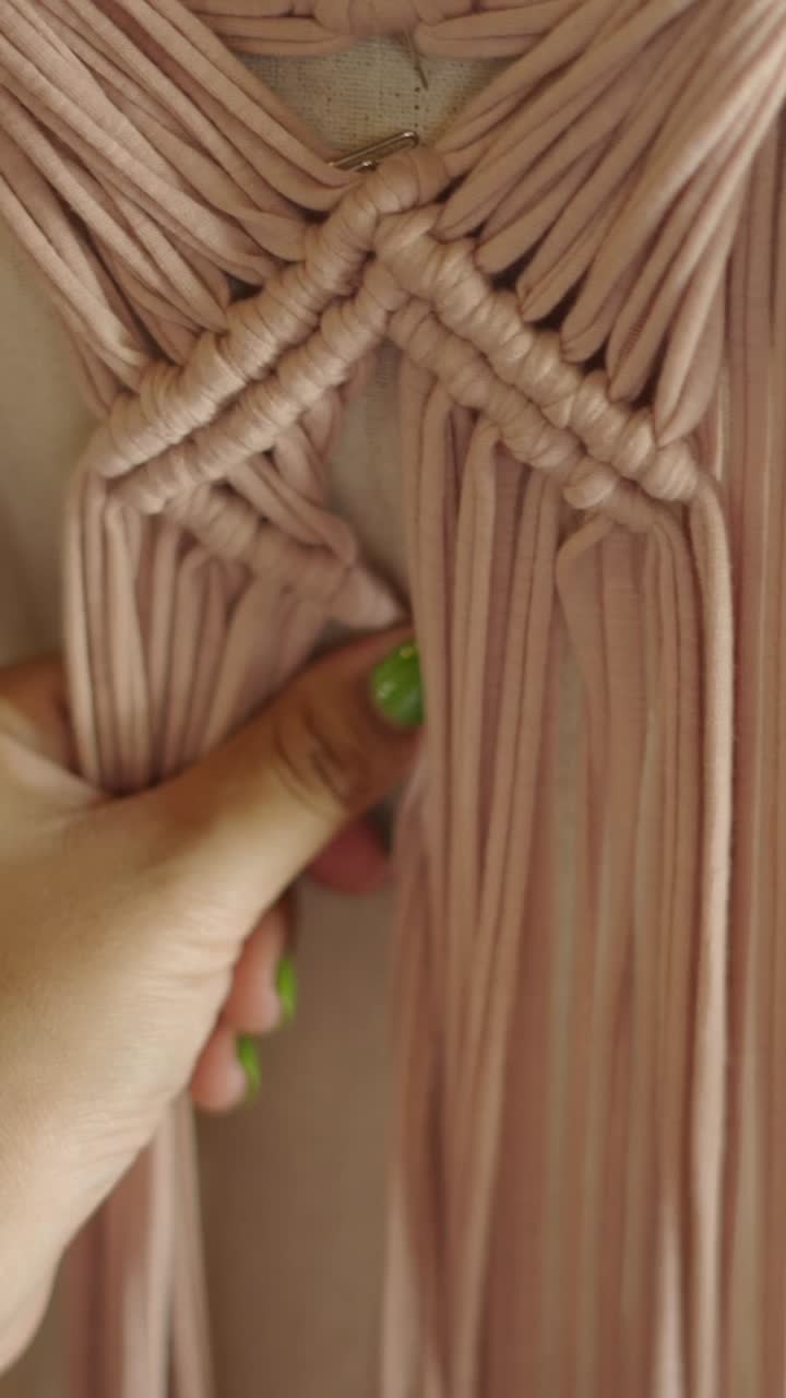 Close-up of hands crafting macrame