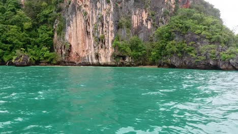 turquoise waters and lush green cliffs