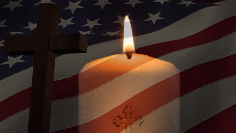 animation of crucifix and candle moving over american flag