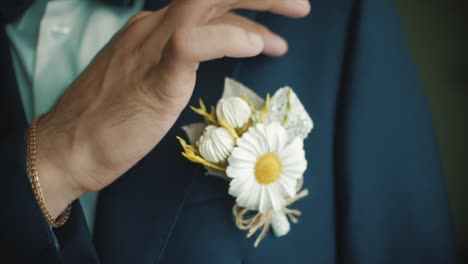 groom in suit with pocket flower