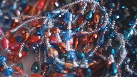 Heap-of-antique-color-bead-necklaces,-close-up