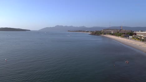 Langkawi-coastline-showing-hotels-and-resorts-on-a-tropical-beach-with-tourists-enjoying-the-clear-blue-water