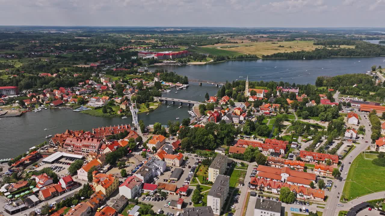 Drone establishing shot of Mikolajki showing lakeside town and sailing hotspot