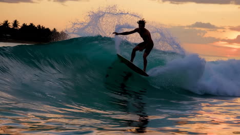 a surfer riding a wave at sunset