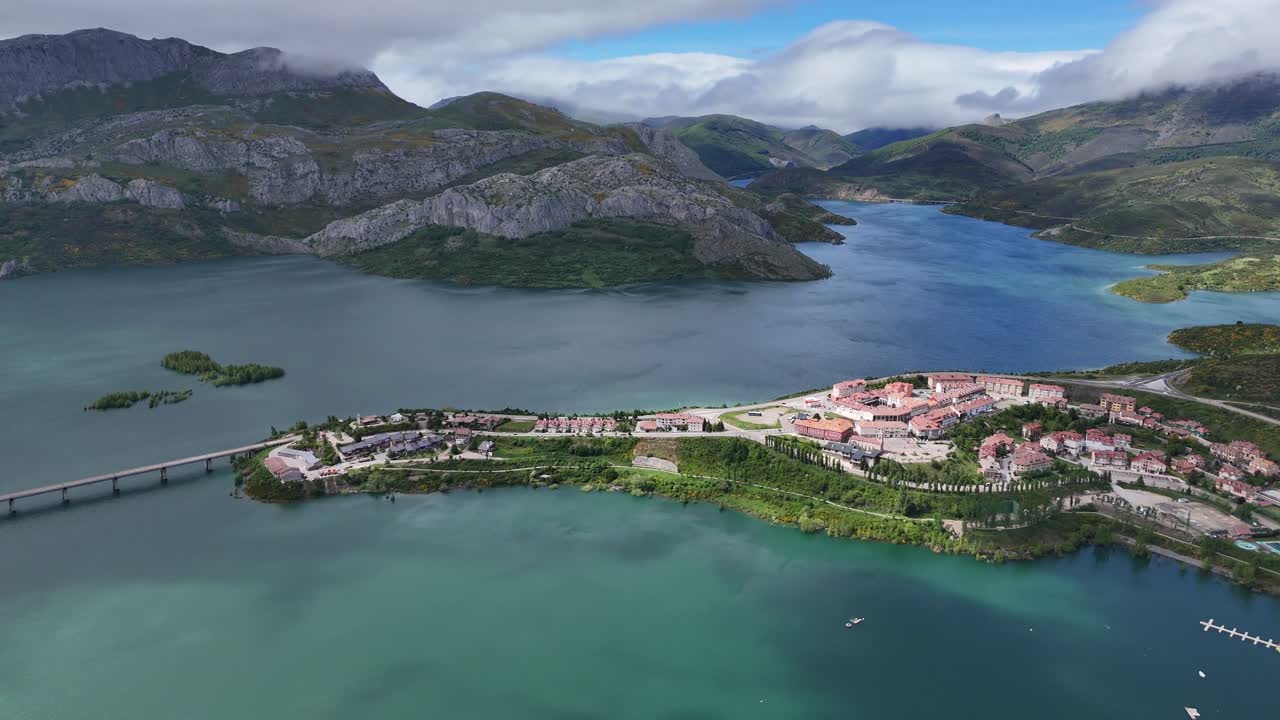 Aerial View of a Town on a Lake Surrounded by Mountains