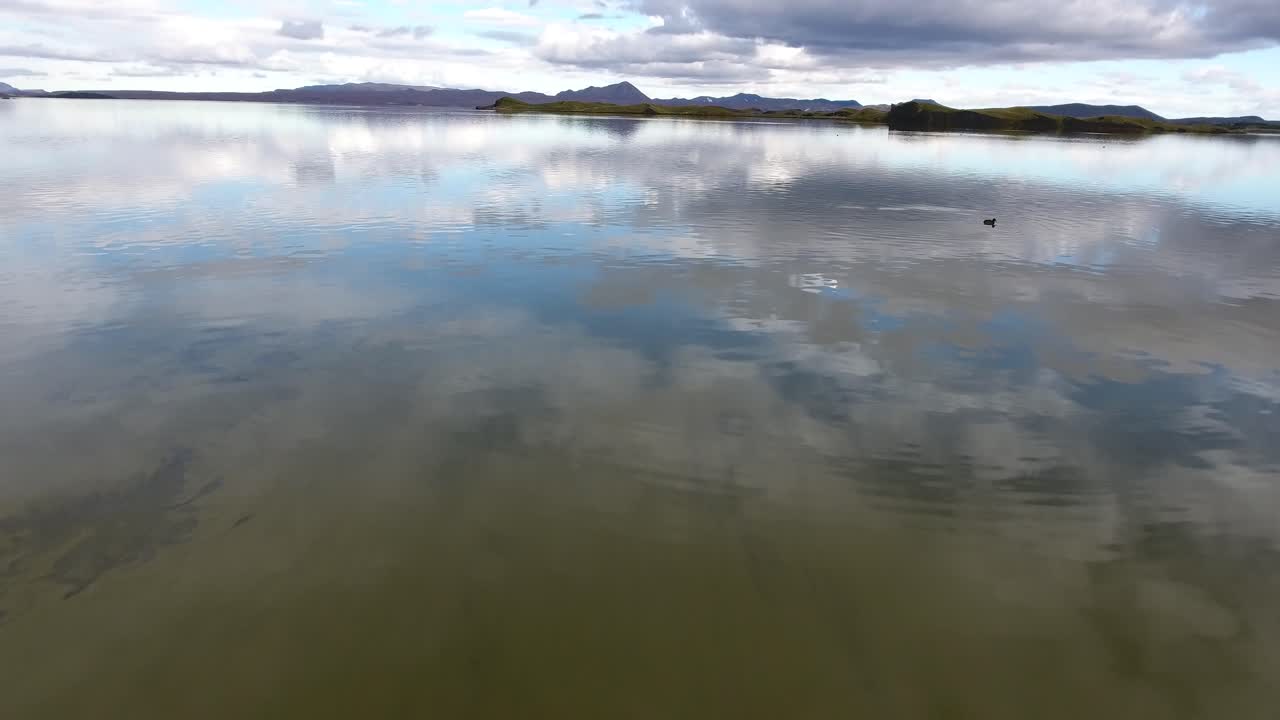 Aerial drone shot flying over Myvatn lake in Iceland. Low altitude flight.