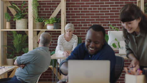 multi ethnic business people using computer working together in vibrant sustainable office workspace