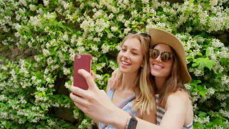 two women taking a selfie in a garden