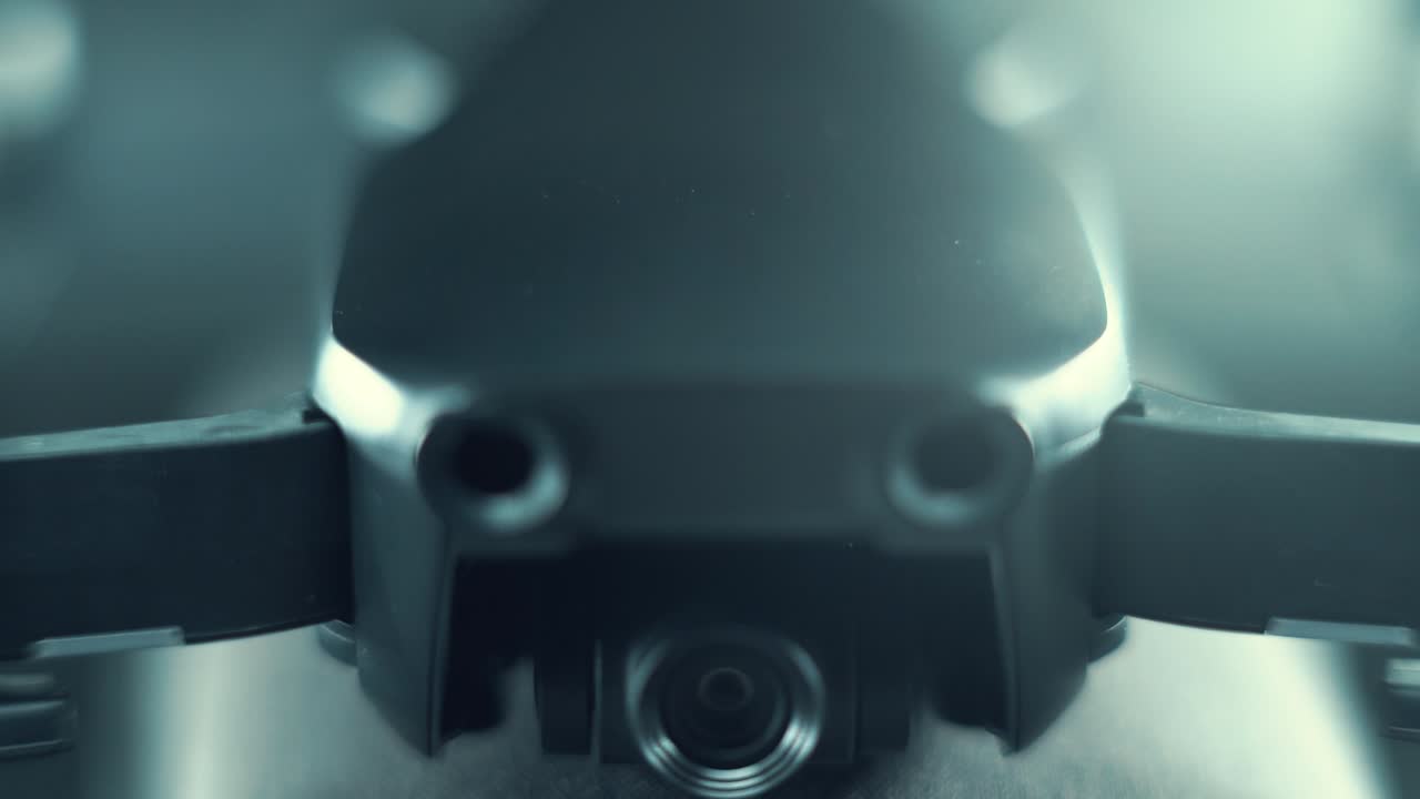 Macro Drone Camera Lens on a stabilizer, propellers and sensors, hyper close up, aerial photography gear, professional film equipment, studio lighting, upwards movement, 120 fps slow motion