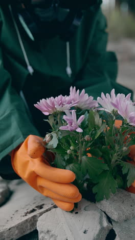 human in hazmat planting in urban city. farming in apocalypsis. vertical video