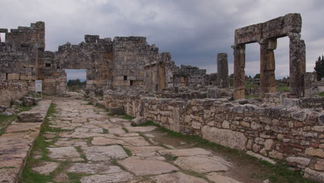 the ruins of buildings along a road in hierapolis