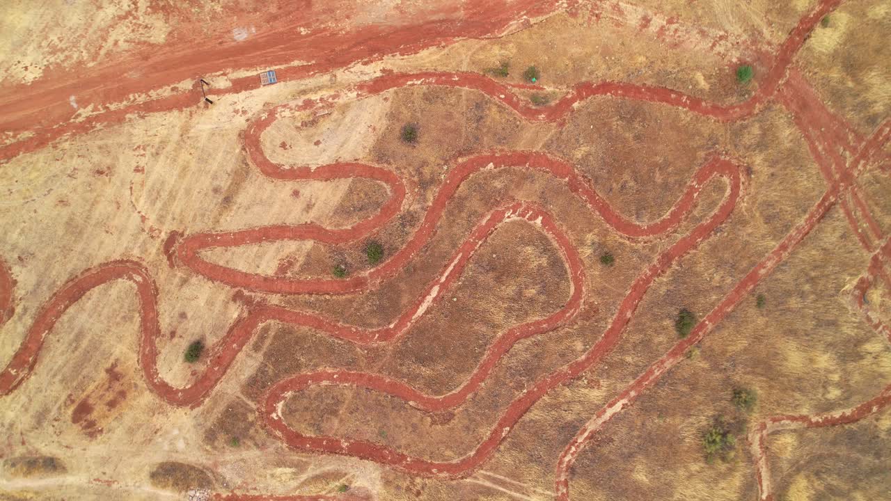 Mountain bike circuit. Ascending aerial view. Mountain bike racing circuit layout seen from the air. Curves and mountain bike competition circuit route. MTB circuit. Granada. Spain.