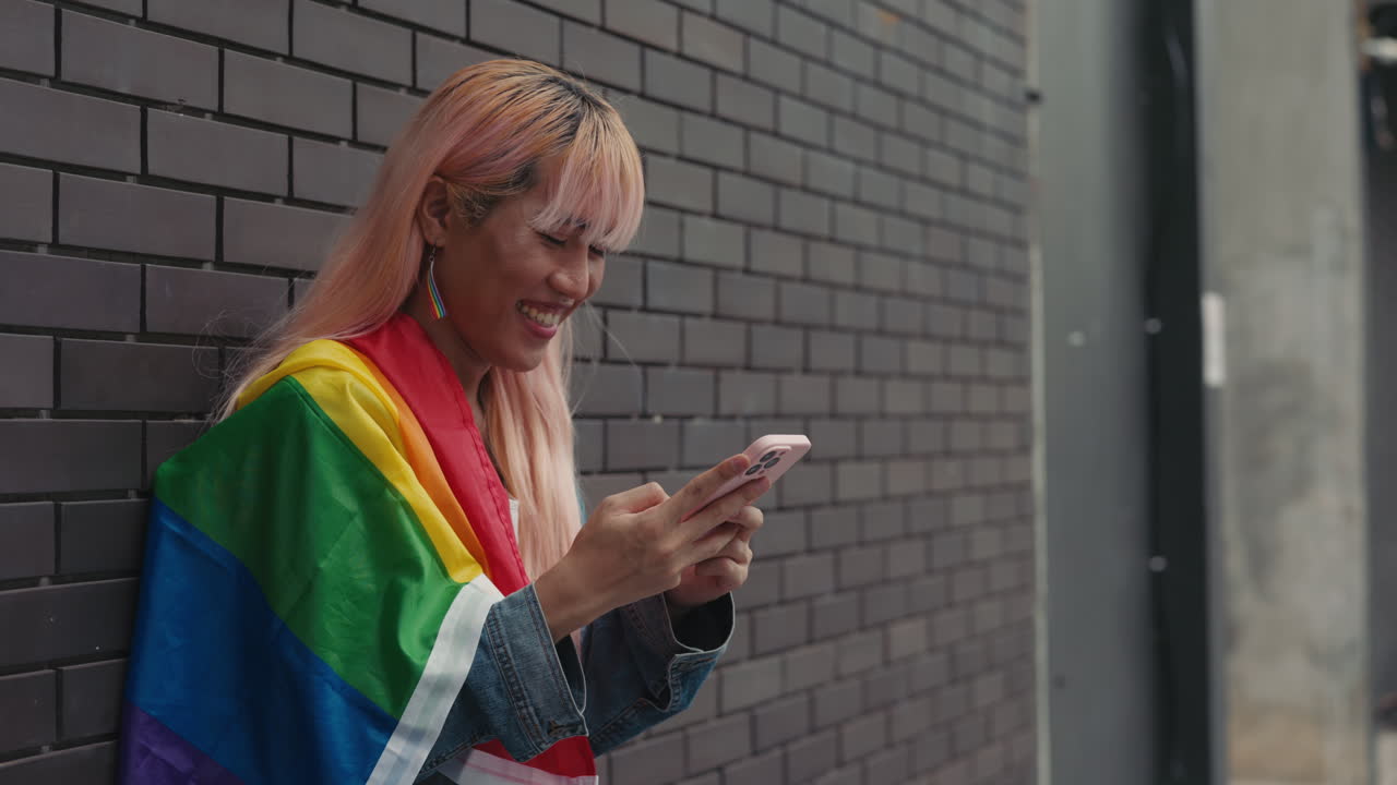 Young Person Using Phone, Pride Flag