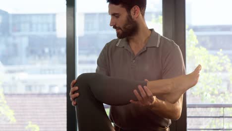 Male-physiotherapist-giving-leg-massage-to-female-patient