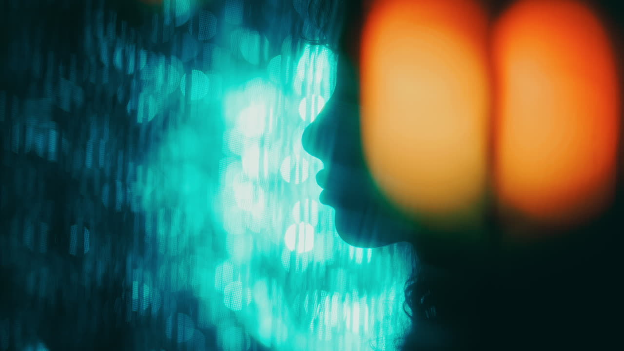 Silhouette of Woman in Profile Surrounded by Contracting Bokeh Lights