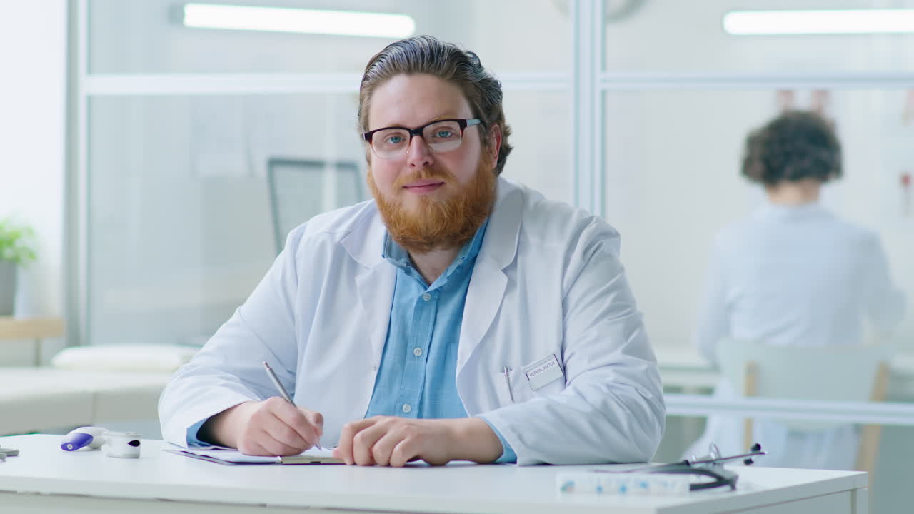 Male Doctor Posing for Camera at Work in Clinic