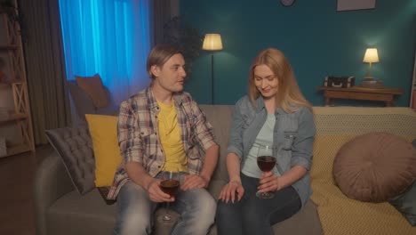 couple relaxing with wine on the sofa