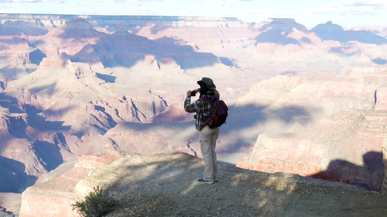 Woman Taking Photo of Grand Canyon Landscape with Smartphone