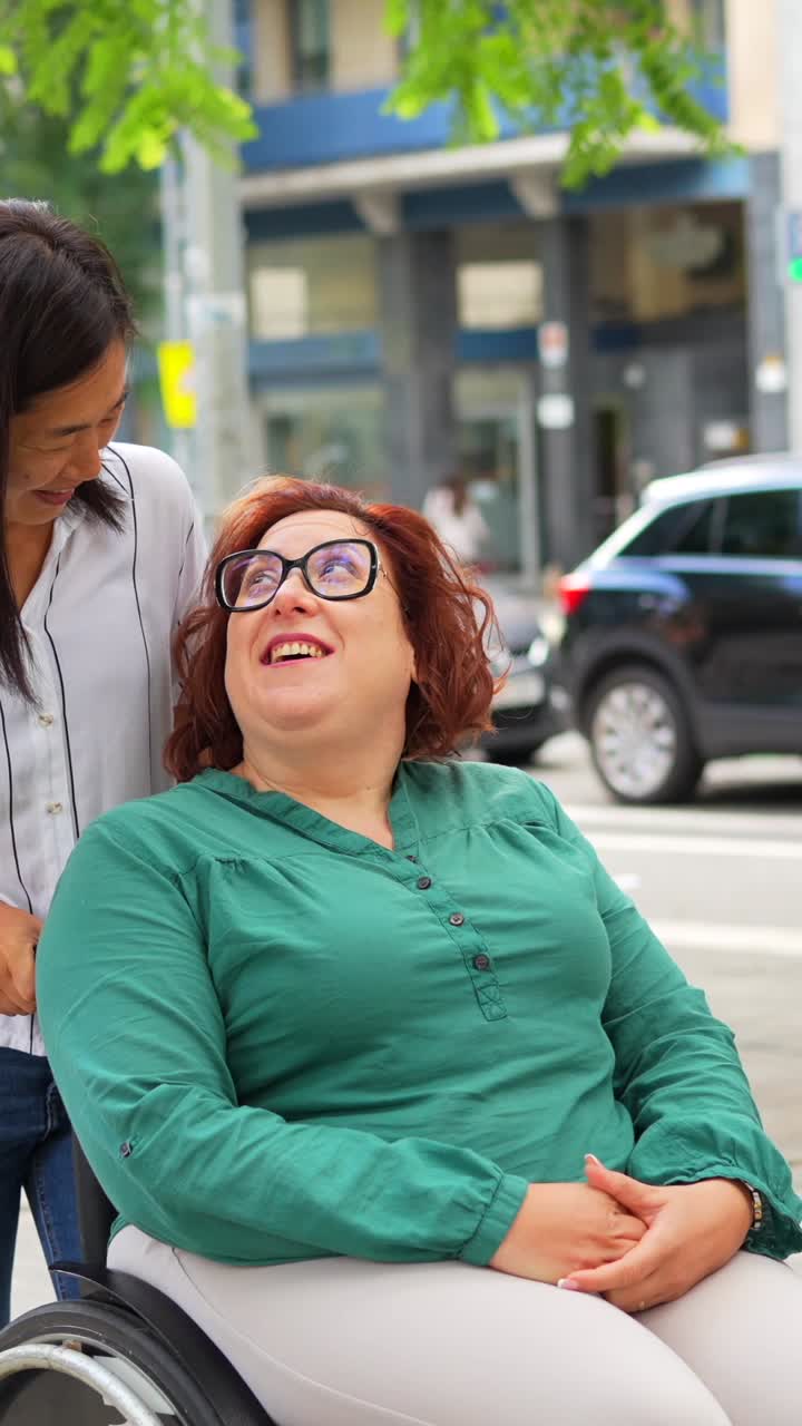 Woman in Wheelchair with Caregiver