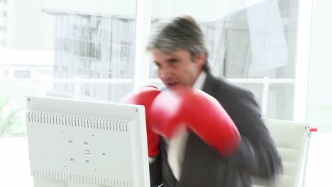 stressed businessman wearing boxing gloves