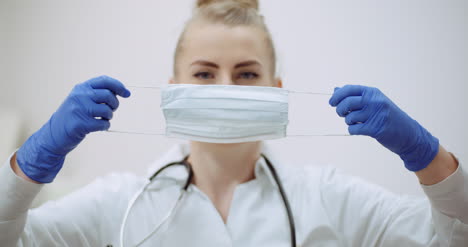 female doctor putting on protective mask at clinic 2