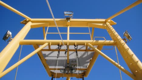 symmetrical lines of a yellow boat with a blue sky as background in slowmotion in 4k