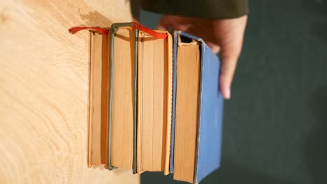 stacked vintage books on a wooden table