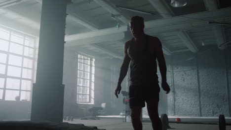 bodybuilder flipping tire in gym. muscular man practicing fitness training